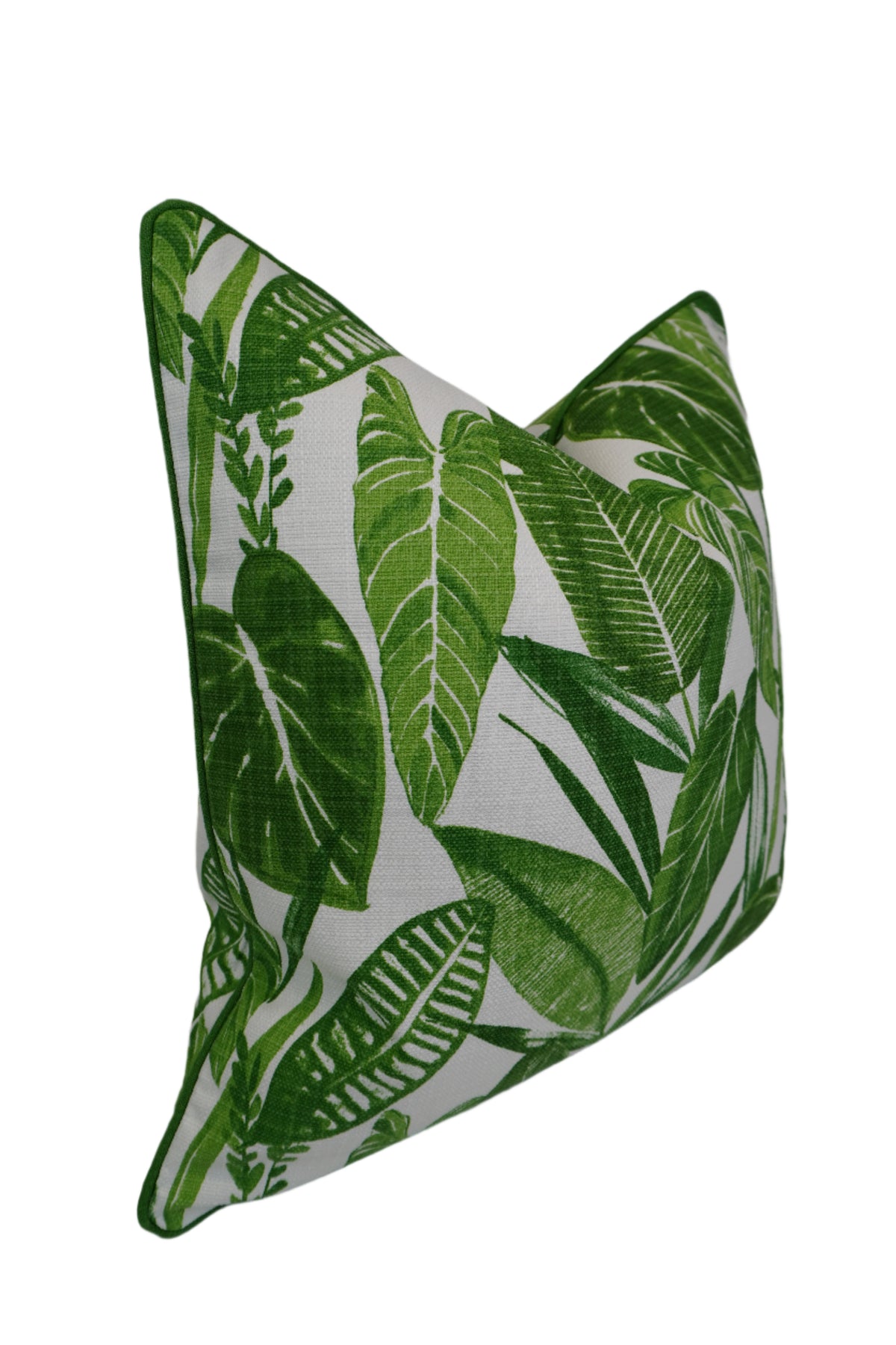 Green leaf-patterned pillow on a white background