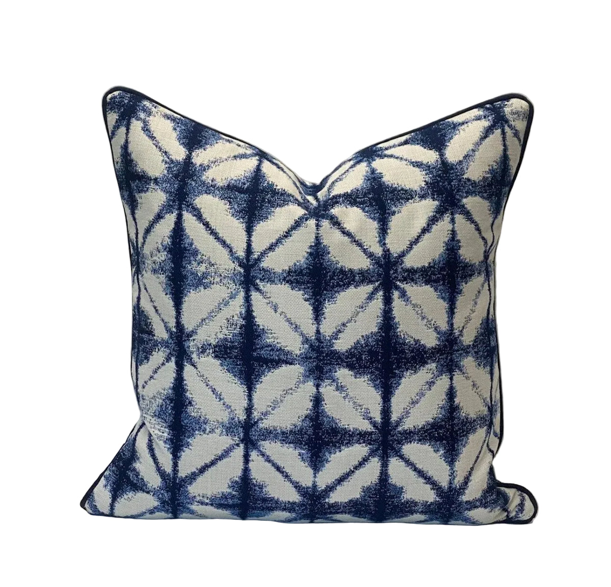 Decorative pillow with blue and white geometric pattern on a plain background