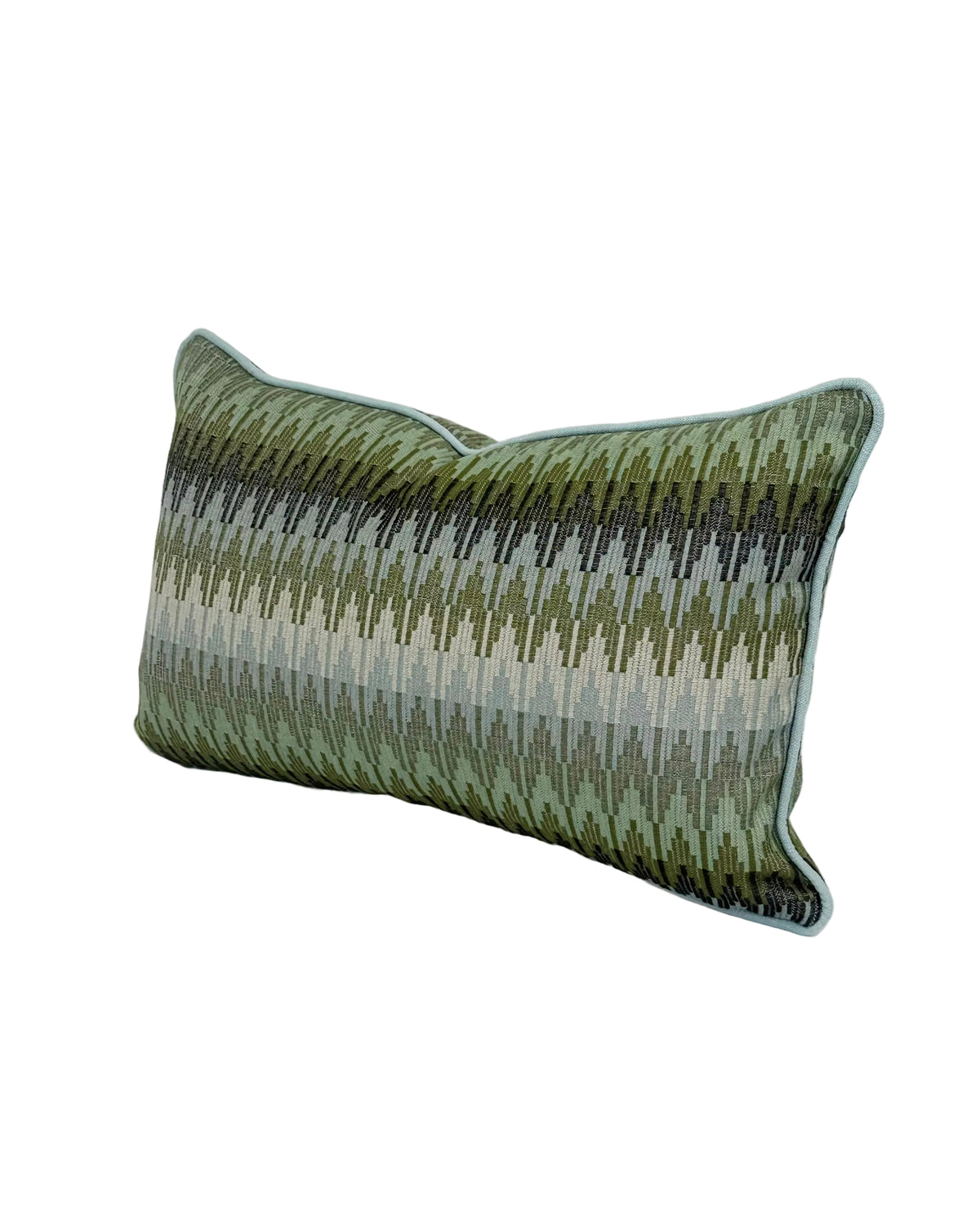 A rectangular lumbar throw pillow with a textured, woven chevron pattern in shades of olive green, and blues, finished with a light blue piped edge, shown on a white background. Finished in a light blue trim.