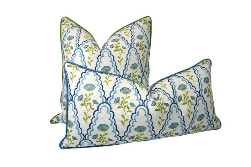 Two decorative pillows with floral patterns on a white background