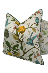 Decorative pillow with a teal hummingbird and floral pattern on a lemon tree on an Ivory-beige background