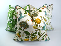 Decorative pillow with a teal hummingbird and floral pattern on a lemon tree on an Ivory-beige background (pictured with two other pillows)
