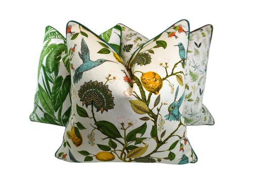 Decorative pillow with a teal hummingbird and floral pattern on a lemon tree on an Ivory-beige background