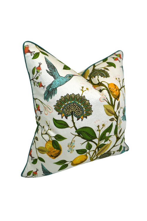 side view of Decorative pillow with a teal hummingbird and floral pattern on a lemon tree on an Ivory-beige background