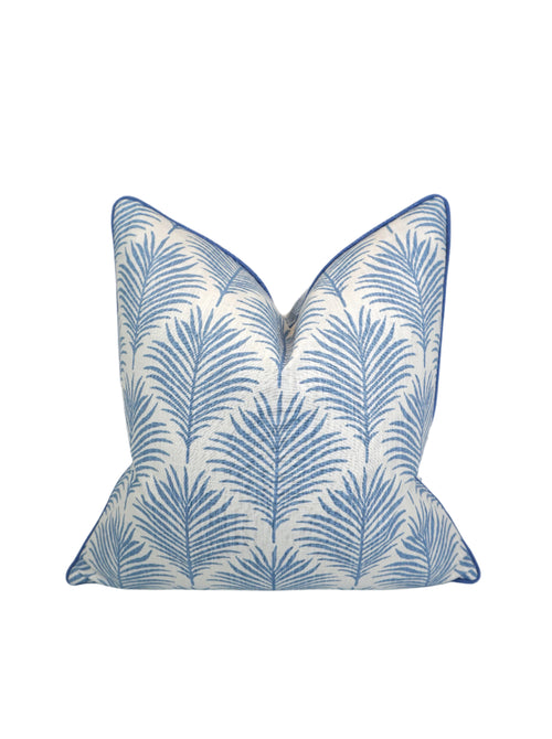 Decorative Pillow with Light Blue Palm leaf design on a white background with blue welt/piping going around the entire edge of Pillow Cover.