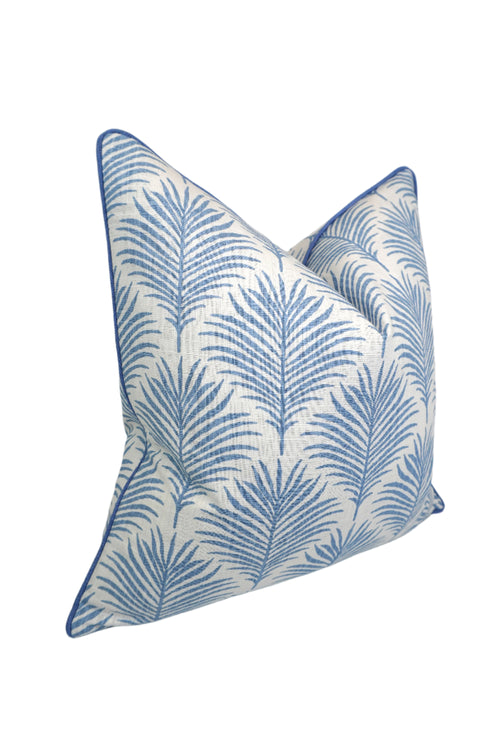 Decorative pillow with blue leaf pattern on a white background