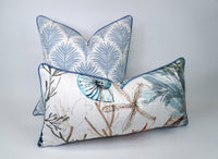 Two decorative pillows with floral and nature-themed patterns on a white-off white background