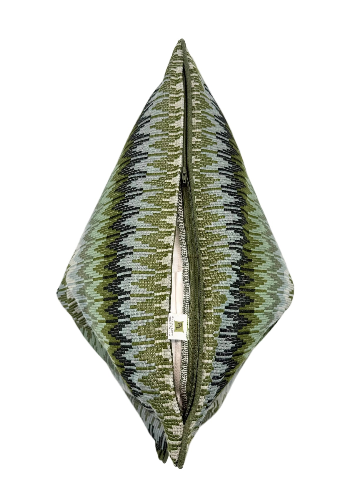 A square decorative throw pillow with greens, and blues, ikat pattern, shown from a top-down view with its center zipper open.
