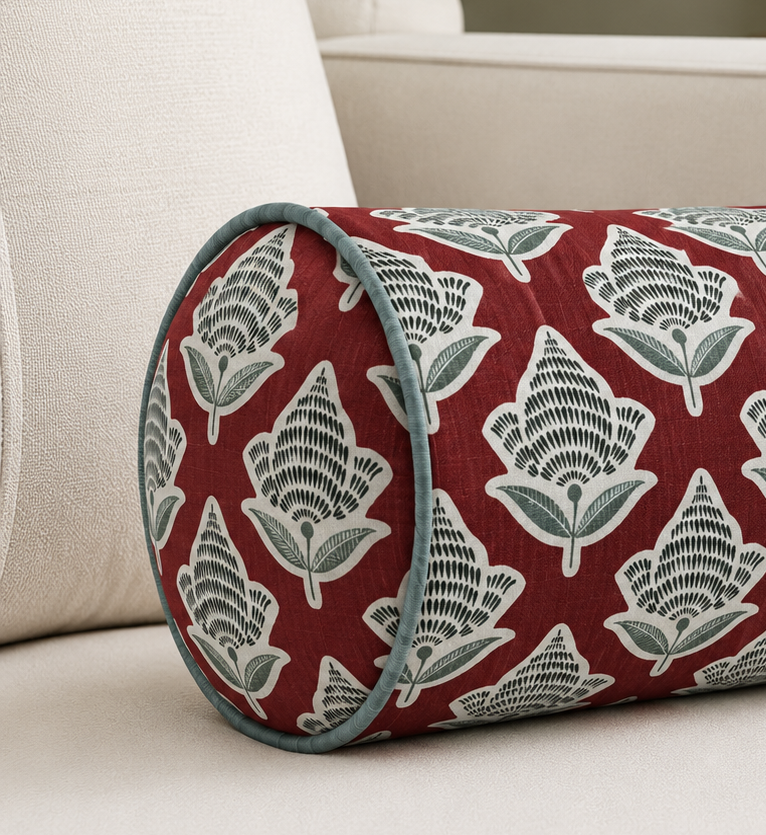 Decorative bolster pillow with floral pattern on a beige sofa