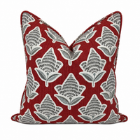 Decorative pillow with leaf pattern on a red background