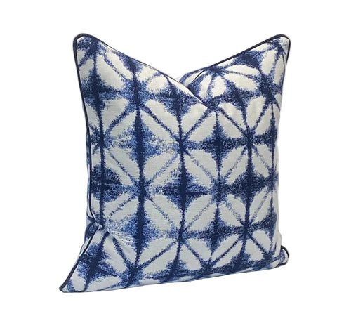 Decorative pillow with blue and white traditional Japanese Shibori dyeing pattern on a plain background
