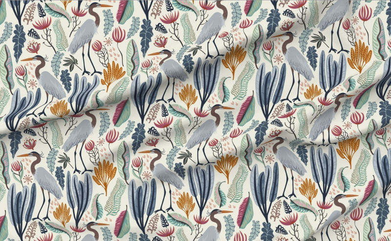 Patterned fabric with birds and plants on a cream background